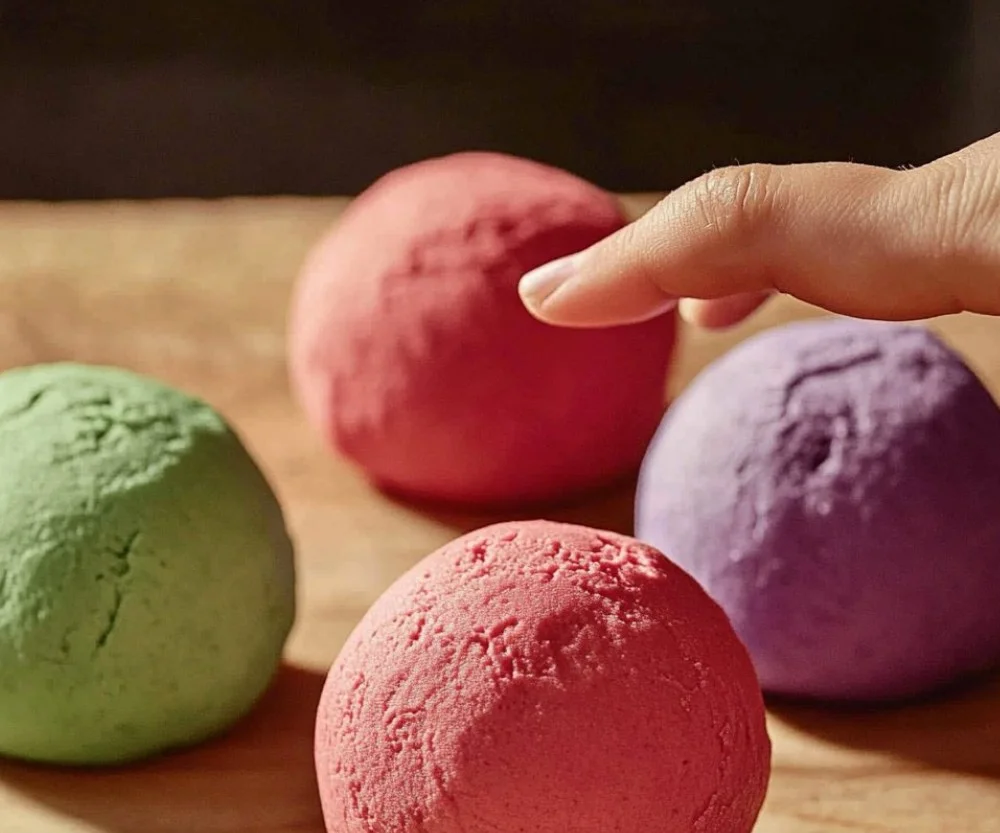 Colorful homemade play dough in various shapes and sizes
