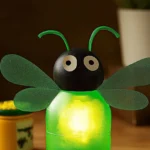 A beautiful scene of glow-in-the-dark fireflies illuminating a dark garden.