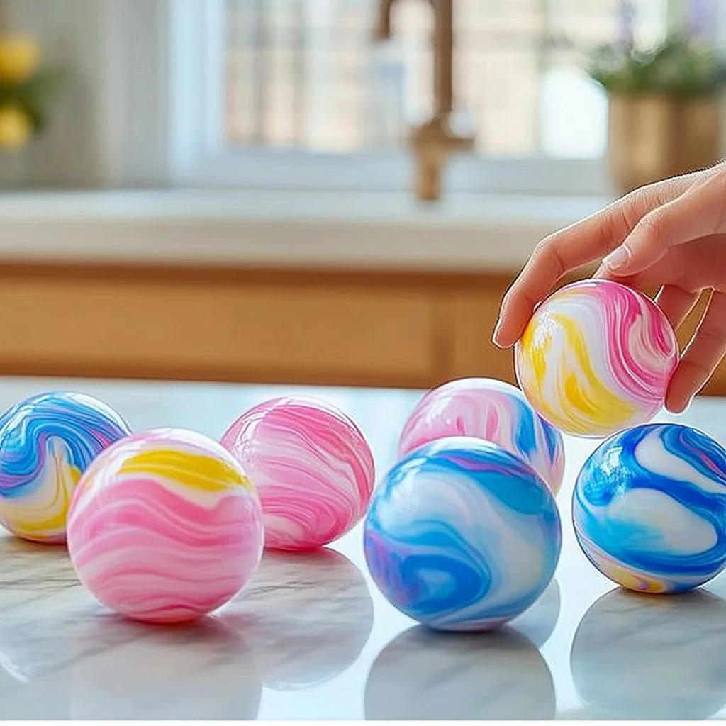 Colorful tie-dye bouncy balls in various sizes and designs.