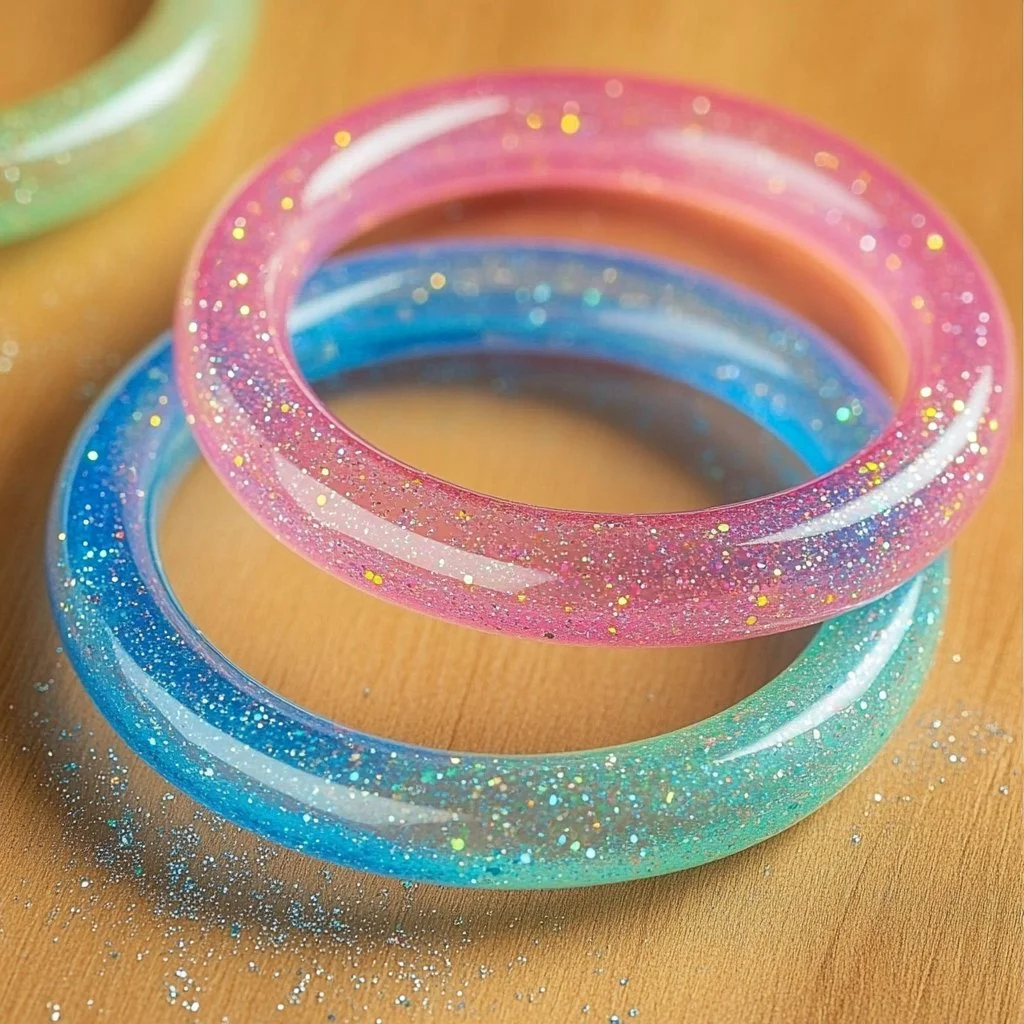 Colorful DIY glitter tube bracelets made with vibrant glitter and tubes.