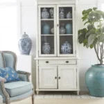 Decorating a large wall in a living room with artwork and stylish decor ideas.