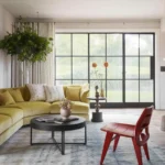 Stylish living room with curved furniture trend including a curved couch and chairs.