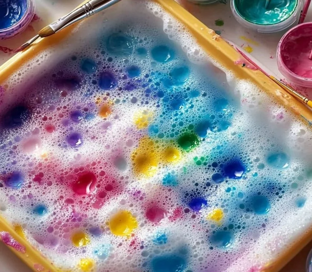 Child enjoying a fizzy painting activity with vibrant colors and bubbles