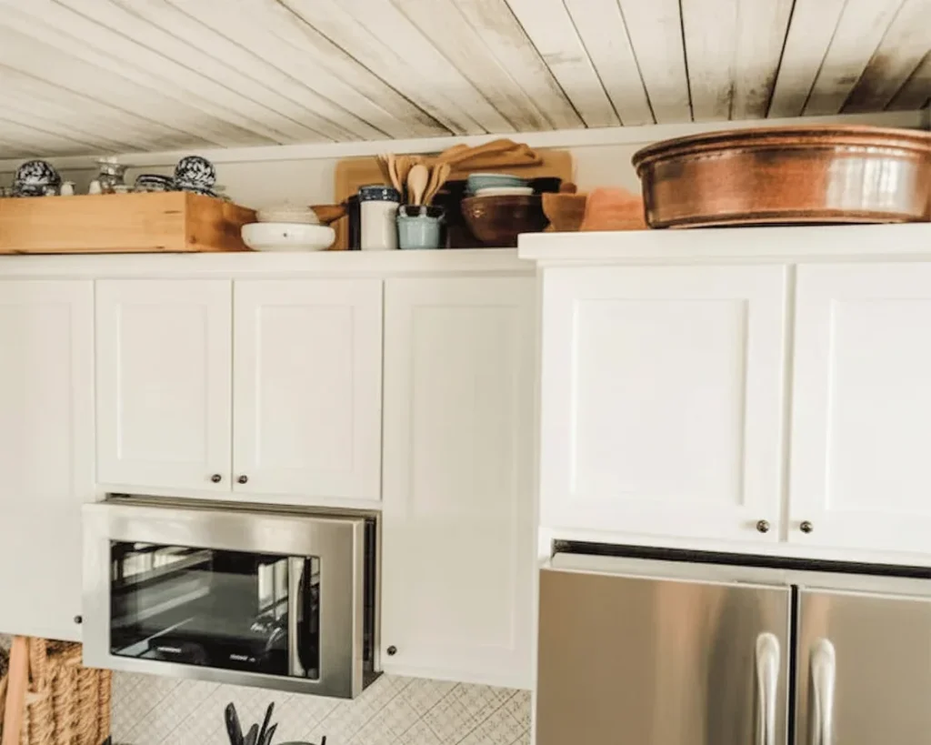 Decorating above kitchen cabinets with plants and stylish storage ideas.