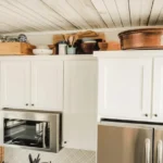 Decorating above kitchen cabinets with plants and stylish storage ideas.