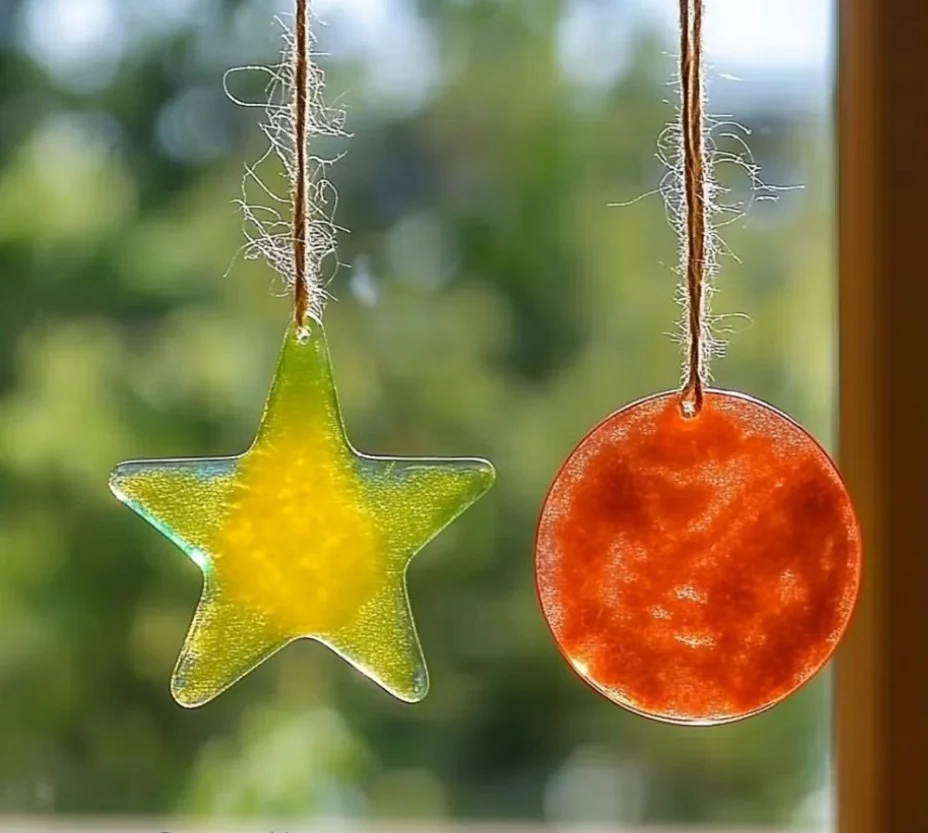 Colorful bioplastic suncatchers hanging in sunlight for eco-friendly decor