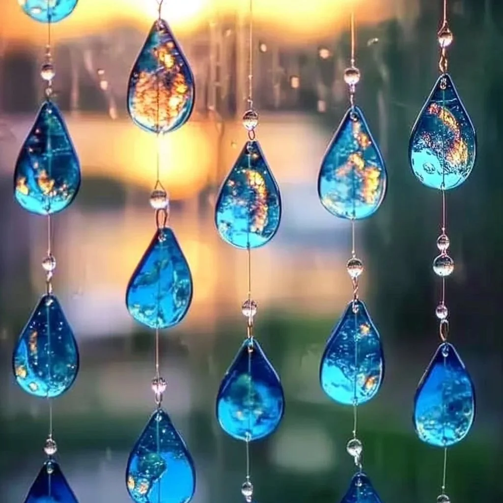 Colorful Blue Crayon Suncatchers hanging in sunlight, casting vibrant shadows.