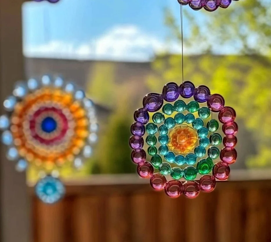 Colorful butterfly suncatchers illuminating a sunlit window display