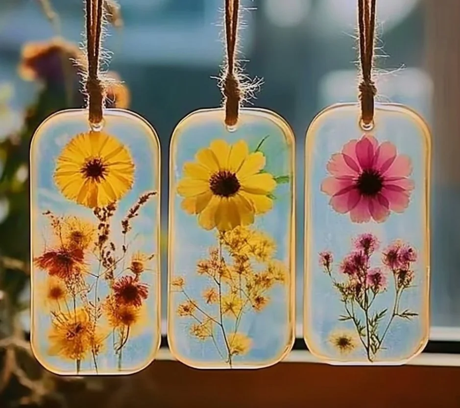 Colorful DIY bioplastic suncatchers hanging in sunlight, showcasing eco-friendly design.