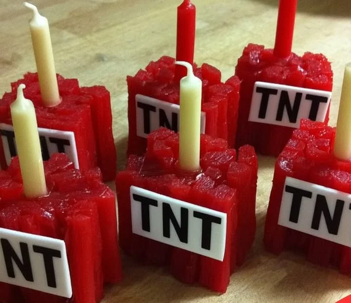 DIY birthday candles designed like Minecraft TNT for a themed party.