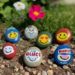Colorful painted garden rocks adding charm to a lush garden landscape.