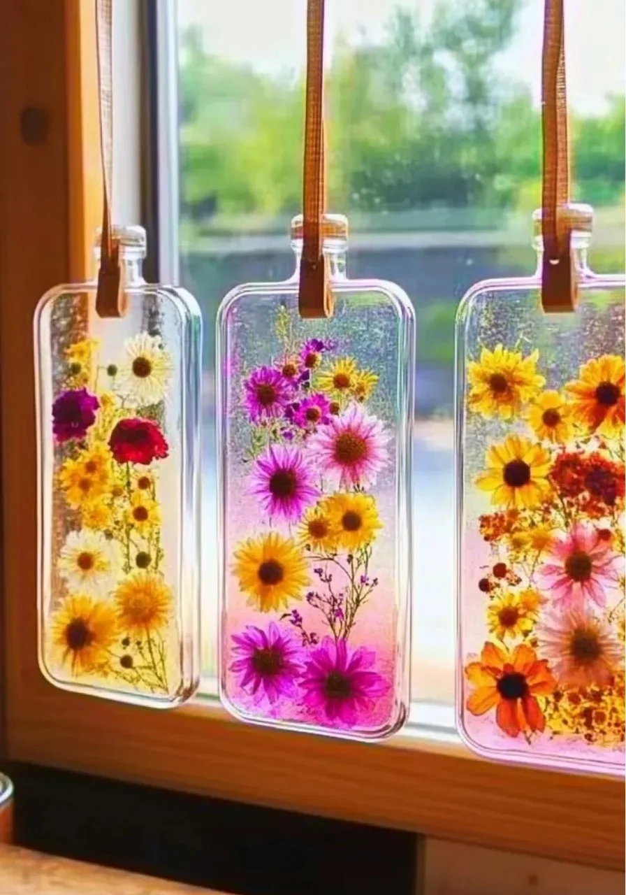 Colorful DIY bioplastic suncatchers hanging in a window
