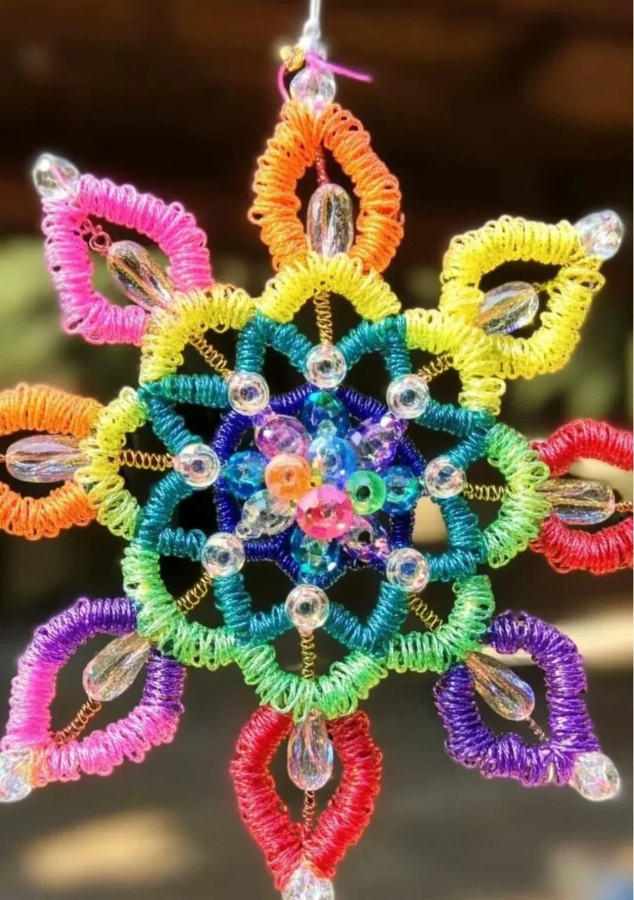 Colorful DIY Rainbow Suncatcher hanging in a window