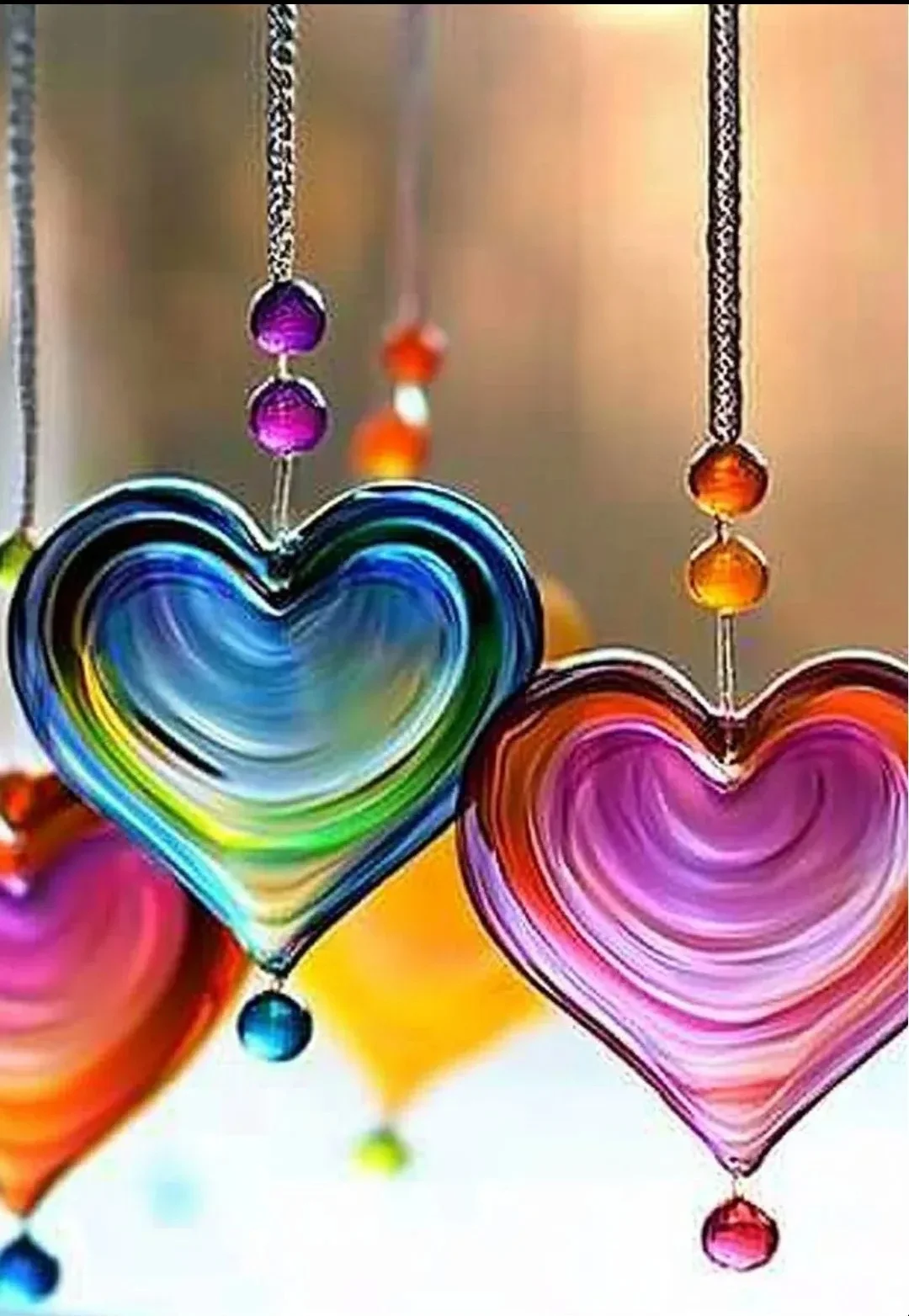 Colorful melted bead suncatchers catching sunlight and brightening a room