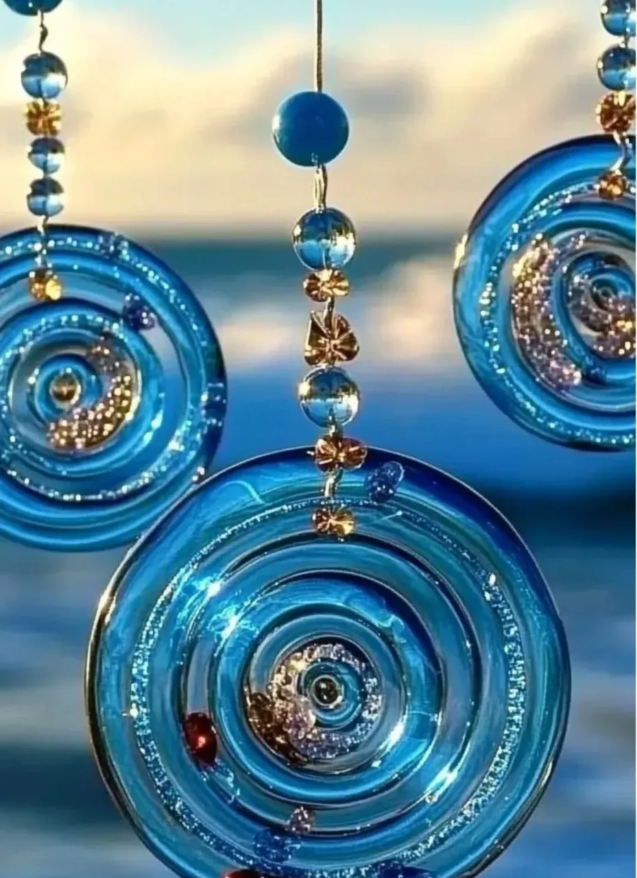 Beautiful ocean themed beaded suncatcher catching sunlight