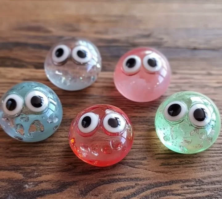 Colorful collection of glass stone bugs for home decor and art.