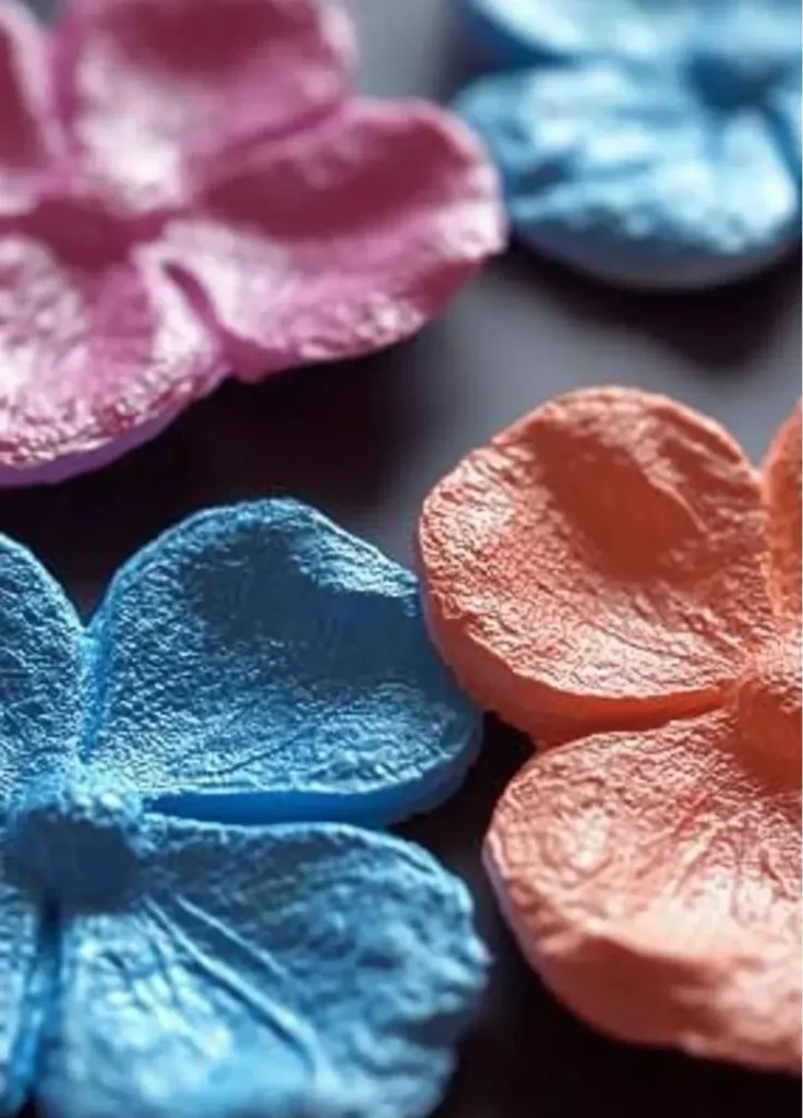 Colorful homemade puffy paint in various containers for arts and crafts projects.