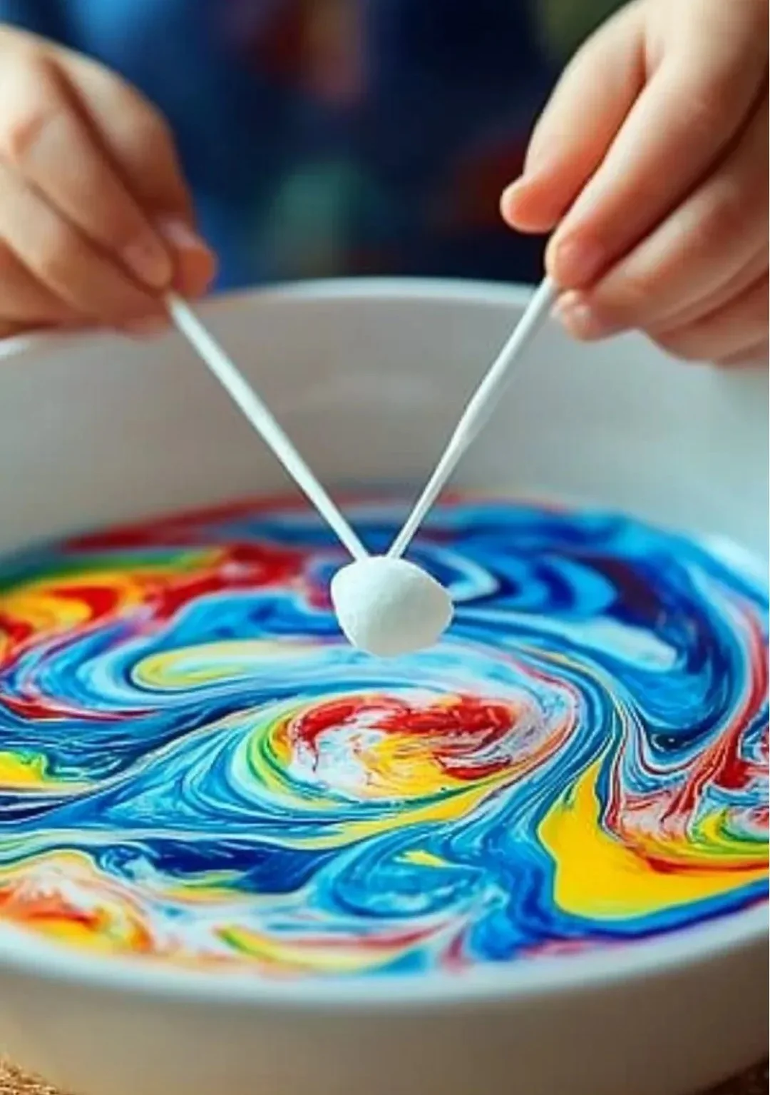 Colorful Magic Milk experiment with swirling food coloring in milk.