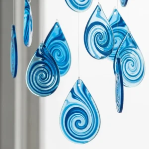 Colorful blue crayon suncatchers hanging in sunlight, creating vibrant reflections