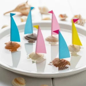 Artistic seashell sailboats displayed as unique nautical decor