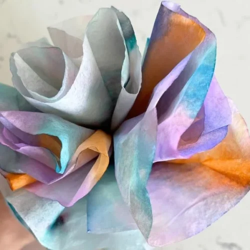 Colorful tie dye coffee filters used in kids' craft activities.