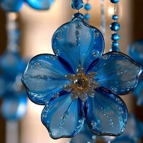 Colorful blue suncatchers hanging in a sunlit window, showcasing a DIY craft project