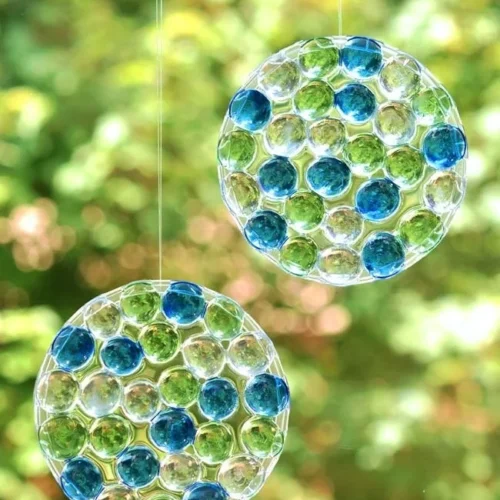 DIY glass bead sun catchers catching sunlight and creating colorful reflections