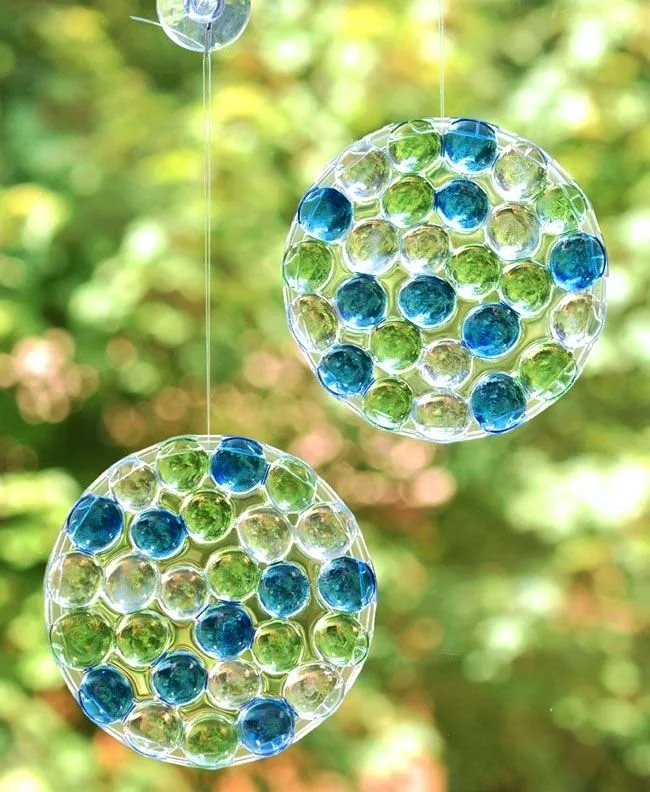DIY glass bead sun catchers catching sunlight and creating colorful reflections