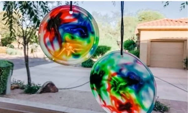 Colorful DIY glue sun catcher hanging in a window