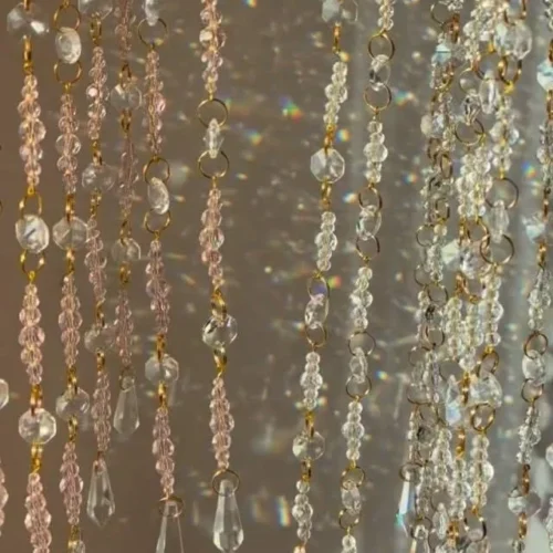 Colorful DIY sun catcher hanging in a window, casting beautiful light patterns.