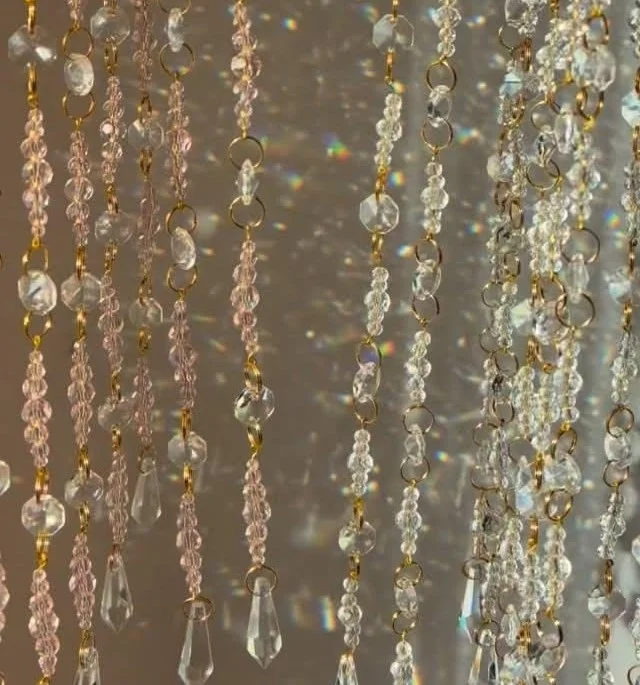 Colorful DIY sun catcher hanging in a window, casting beautiful light patterns.