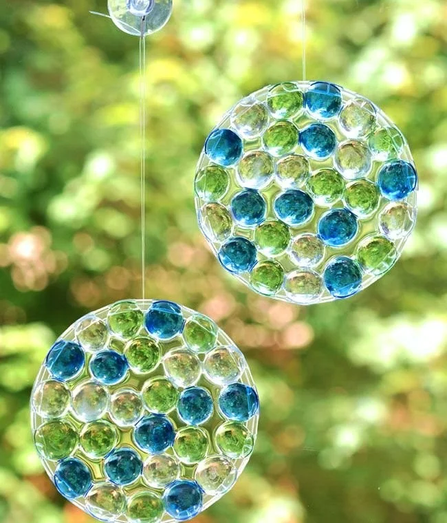 DIY sun catchers made with colorful glass beads hanging in sunlight