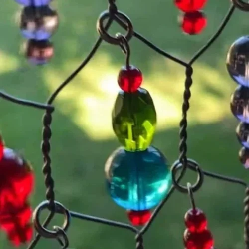 DIY sun catcher made from wire mesh with colorful beads