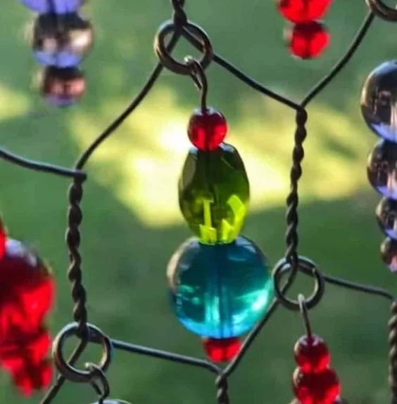DIY sun catcher made from wire mesh with colorful beads
