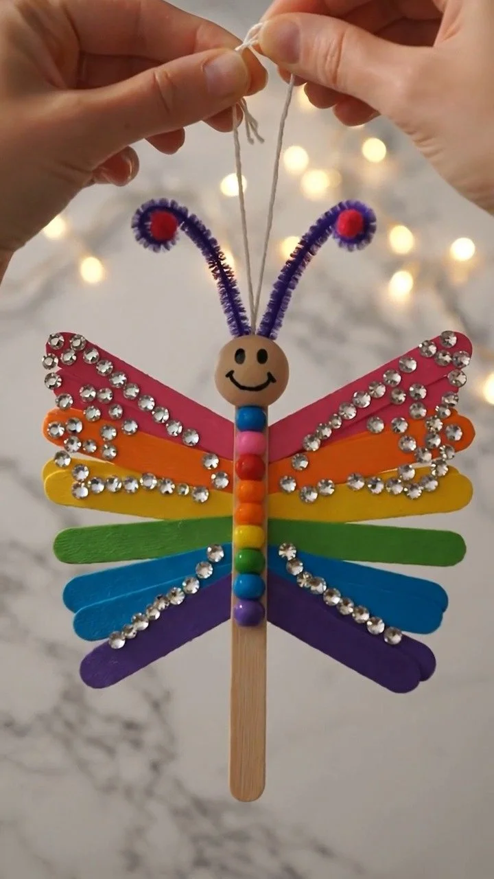 Moving popsicle stick butterfly craft creates colorful fluttering butterflies with fun moving wings ✨ A creative kids DIY. Save this project! #ButterflyCraft #PopsicleStickCraft #KidsArt #CreativeKid