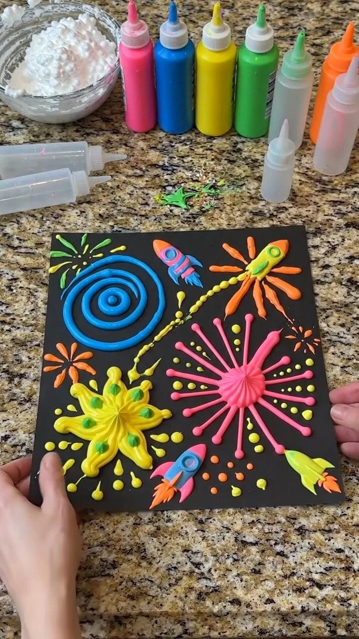 Puffy paint fireworks night sky creates colorful raised fireworks bursting across a magical nighttime scene ✨ A fun art activity for kids. Save this project! #FireworkCraft #PuffyPaint #KidsArt #Crea...