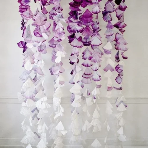 Colorful and creative coffee filter crafts displayed on a table.