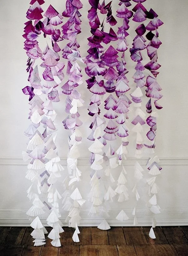 Colorful and creative coffee filter crafts displayed on a table.